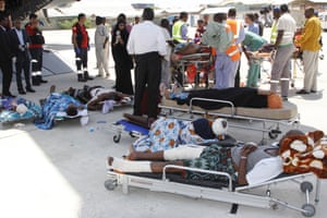 In Mogadishu, critically wounded people wait to be moved into a waiting Turkish plane to be airlifted by air ambulance for treatment in Turkey, on Monday 16 October