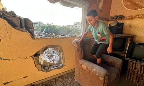 A child helps with a search and rescue operation in a building hit by an airstrike in Gaza City.