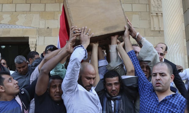 People carry the coffin of police captain Ahmed Fayez, who was killed in the gun battle in Giza province. 
