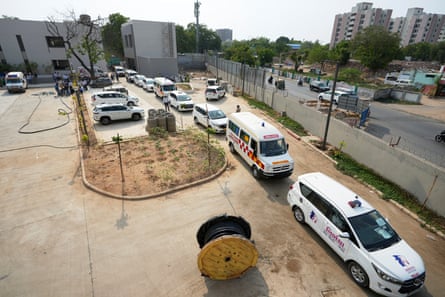 Line of white ambulances in a hospital carpark