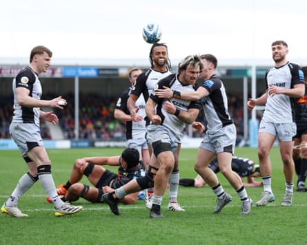 Max Clark of Newcastle Falcons celebrates with teammates after scoring a try