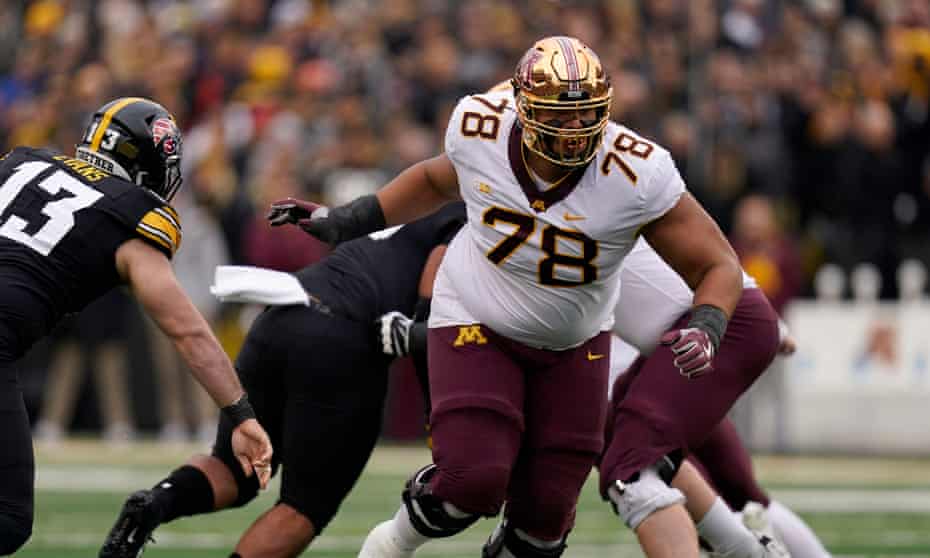 Australian Daniel Faalele playing for Minnesota as offensive tackle in an NCAA college game against Iowa.