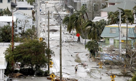 A man walks through a street among damaged homes and businesses and debris in Fort Myers Beach, Fla., on Thursday, Sep 29, 2022, following Hurricane Ian. (Douglas R. Clifford/Tampa Bay Times via AP)