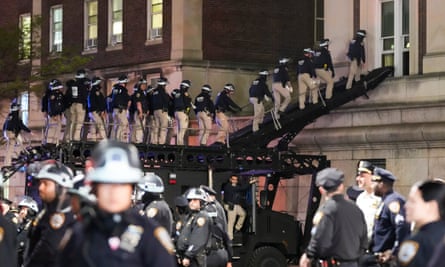 Officers using a ramp to enter Hamilton Hall.