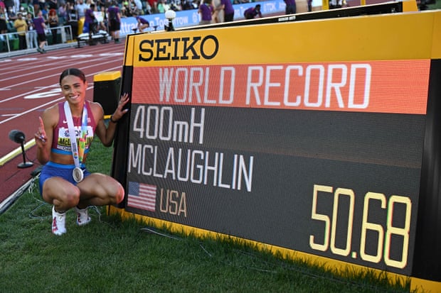 Sydney Mclaughlin poses with a sign showing her time after winning the women’s world 400m hurdles final in Eugene and breaking her own world record.