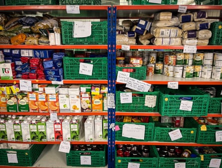 Donated food is seen stored on shelves inside a food bank in Bristol, England