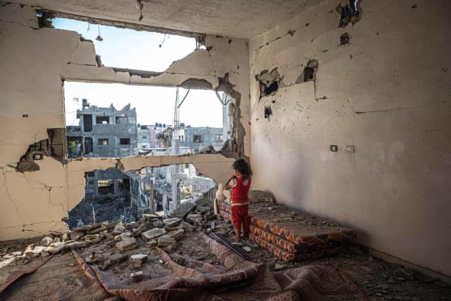 A Palestinian girl stands amid the rubble of her destroyed home on May 24, 2021 in Beit Hanoun, Gaza.