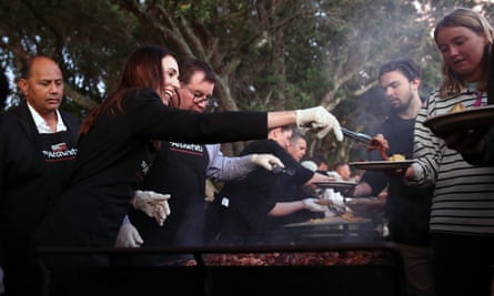 New Zealand’s prime minister, Jacinda Ardern, works on the barbecue after the Waitangi Day dawn service