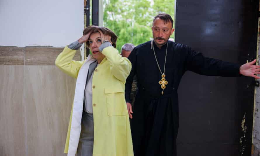 French Foreign Minister Catherine Colonna reacts as she and Andrii Holovine, priest of the Church of St. Andrew Pervozvannoho All Saints, enter the church at the site of a mass grave in the Ukrainian town of Bucha, near Kyiv.