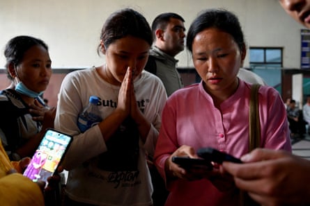 Family members check a list of people who were injured, outside a trauma centre of Bir Hospital in Kathmandu.