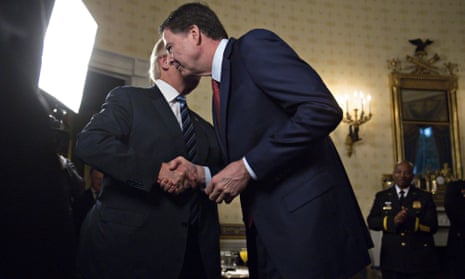 Donald Trump shakes hands with Jamese Comey at the White House on 22 January 2017.