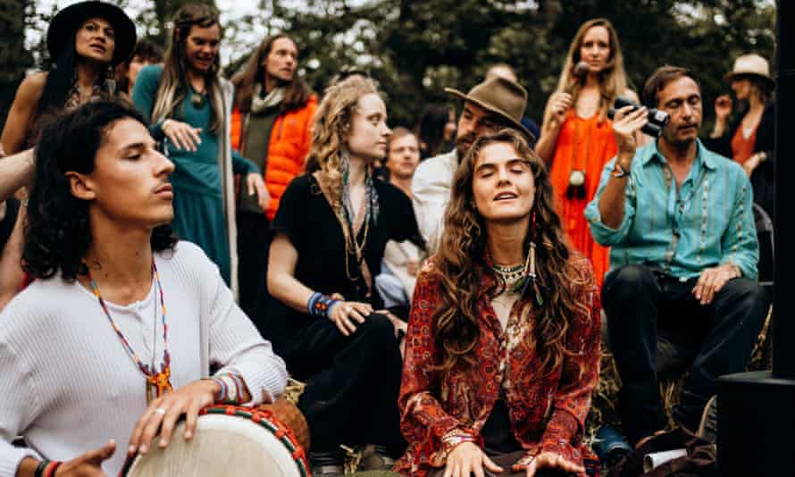 Guests astatine  the Medicine festival adjacent   Berkshire, UK, instrumentality     portion  successful  a storytelling and opus  league   astir   a occurrence  circle, during the daytime.