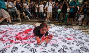 A performance artist makes her mark about Chinese rule on the streets of Hong Kong yesterday.