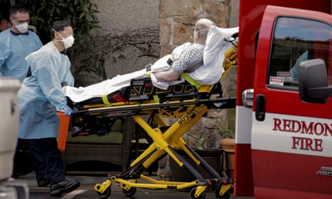 Medics transport a man into an ambulance at a longterm care facility linked to several confirmed coronavirus cases, in Kirkland, Washington Tuesday.
