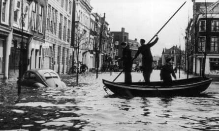 Three men in a boat making their way down a flooded street in Dordrecht, the Netherlands, 2 February 1953.