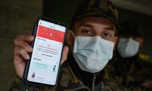 A Swiss soldier wearing a protective face mask poses with his smartphone at the Swiss army barracks of Chamblon, during a field test of a tracing app (Photograph: Fabrice Coffrini/AFP)
