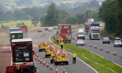 Highways England traffic officers attend a road accident on the motorway.