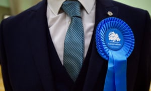 A person wearing a Conservative party rosette