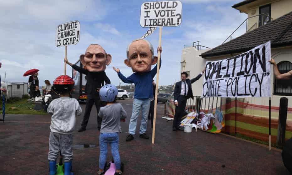 Protesters dressed as former Prime Minister’s Tony Abbott and Malcolm Turnbull are seen outside the venue where candidates for the seat of Wentworth were attending a community forum.  (AAP Image/Dean Lewins)