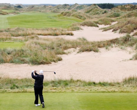 Donald Trump tees off as he plays golf at the opening ceremony for the Trump International Golf Links in Balmedie.