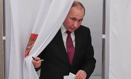 Russian president Vladimir Putin emerging from a polling booth.