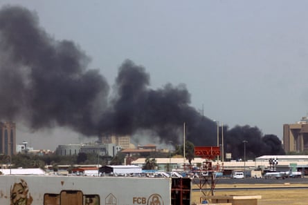 Smoke bellows above buildings in the vicinity of Khartoum airport on 15 April 2023, amid clashes in the Sudanese capital