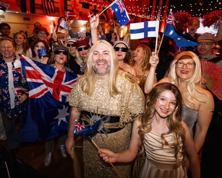 Crowd dressed in gold and waving flags