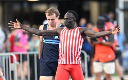 Gout Gout celebrates in a red and white singlet.