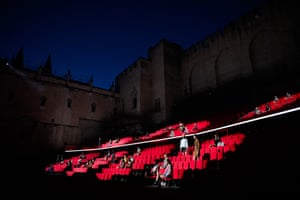 Models appear at night at the courtyard of honour at the Palais des Papes in Avignon