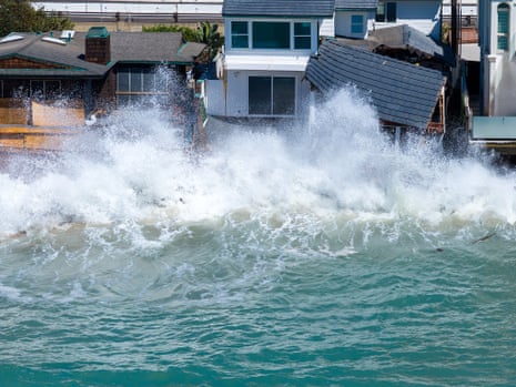 a wave crashing into houses