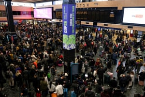 Travellers wait at Euston Station after bad weather led to the cancellation of trains to Glasgow and the Cop26 summit