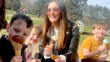 Frankie Jules-Hough with three young boys on a sunny afternoon, all eating ice creams.