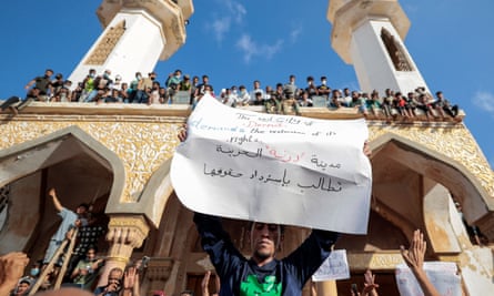 People who survived the deadly storm that hit Libya, protest outside the Al Sahaba mosque in Derna.
