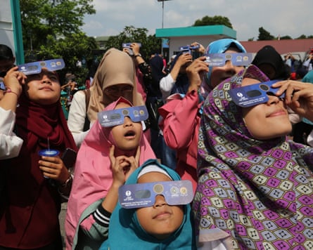 Children use special glasses to watch the solar eclipse in North Sumatra, Indonesia, in 2019.