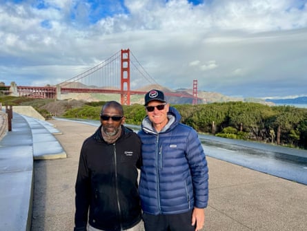 Two men pose in front of the Golden Gate Bridge.