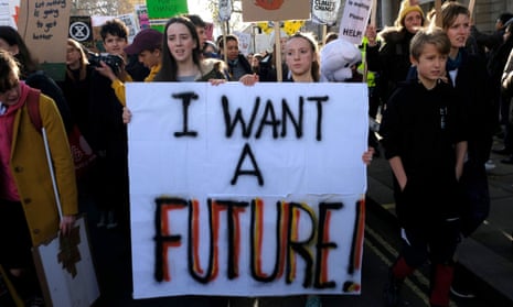 Children and adults hold a banner and placards during the climate change protests on 29 November 2019.