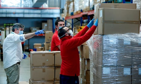 Workers sort out protective equipment from China at a warehouse in Valencia, Spain.