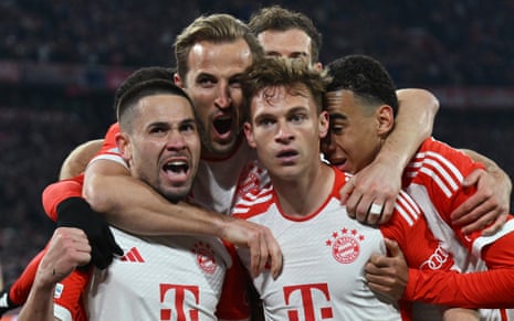 Bayern Munich's Joshua Kimmich (second right) celebrates scoring their first goal against Arsenal with Raphael Guerreiro, Harry Kane and Jamal Musiala.