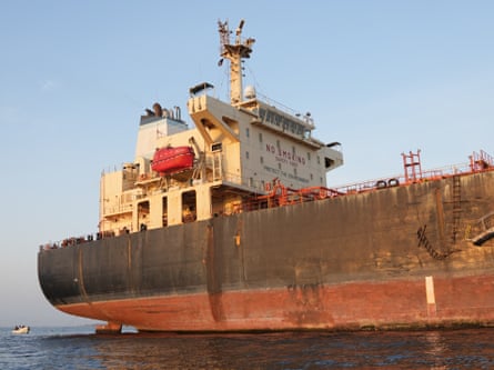 A large shipping vessel sits on a body of water.