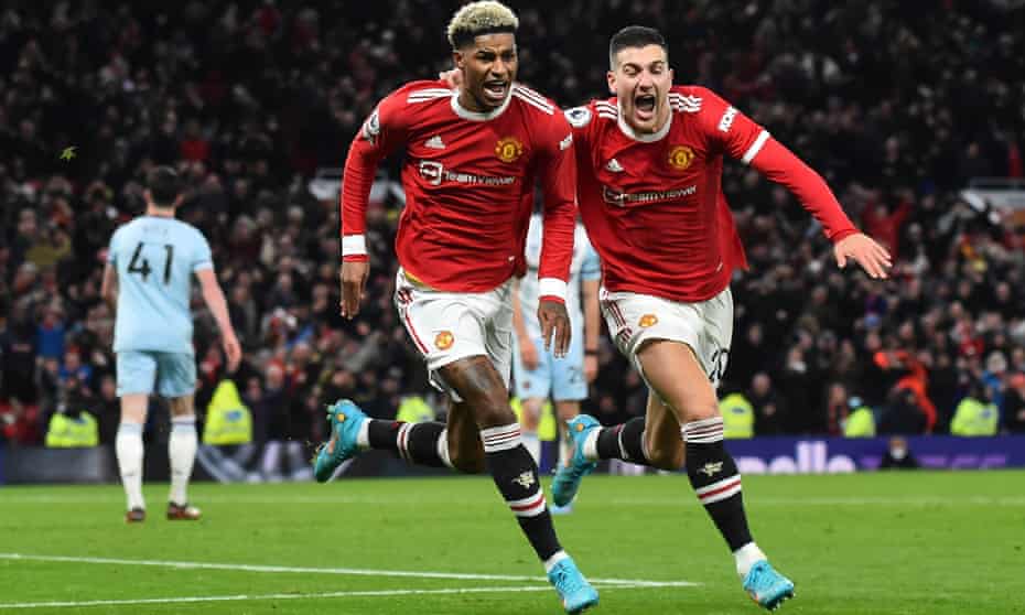 Marcus Rashford celebrates with Diogo Dalot after scoring a late winner.