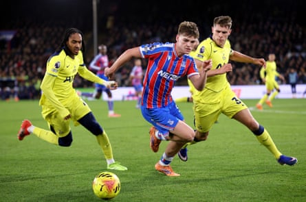 Crystal Palace’s Justin Devenny battles for possession with Tottenham’s Micky van de Ven (right).