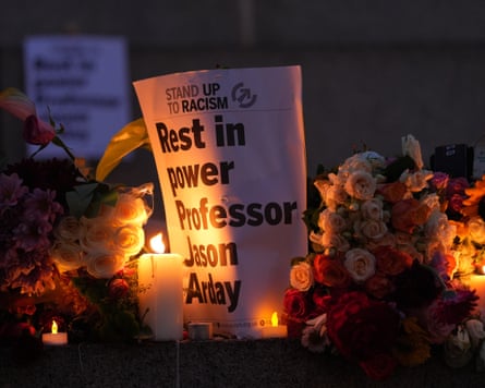 A memorial sign reading “Rest in power Professor Jason Arday” surrounded by flowers and lit candles.