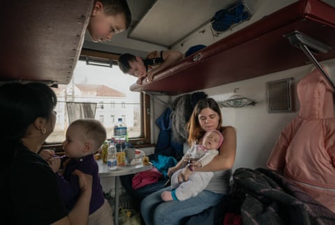 A woman nurtures her baby in a carriage reserved for children with special needs in the evacuation train from Kryvyi Rih to Chop