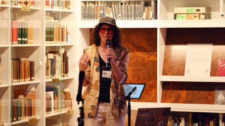 A man sings into a microphone during Robot Karaoke at Friday Lates, V&A.