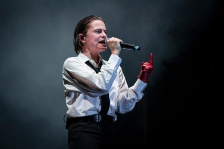 Rahim Redcar of Christine and the Queens performs in a white shirt and red glove.