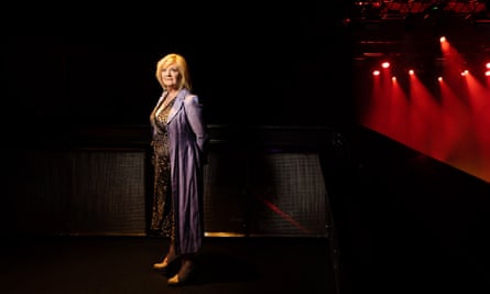 Nicki French, who appeared in Eurovision 2000, standing on a stage with spotlights behind her