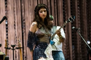 Clairo on stage with a guitarist