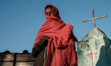 A female Ethiopian refugee prays at a church near Um Raquba  camp in neighbouring Sudan.