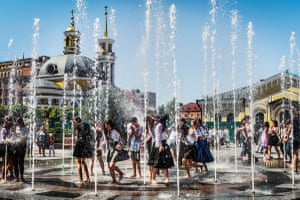 Graduating students from schools around Kyiv play in a fountain