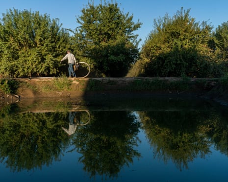 A man on walking by a water reserve
